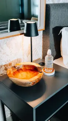 a bowl of food sitting on a table with a lamp at Urban Gem on 18th Prime Location in Pretoria
