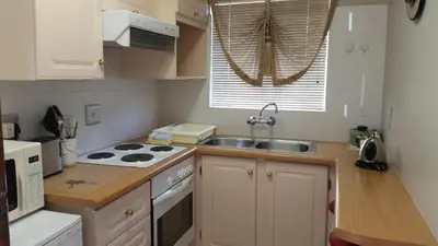 a kitchen with a sink and a stove top oven at Royal Ridge Guesthouse in Pretoria