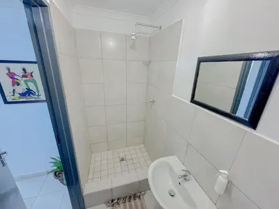 a white bathroom with a toilet and a sink at Berry Bliss Haven in Pretoria