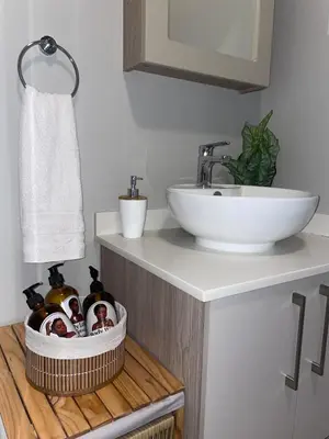 a bathroom with a sink and a counter with a toilet and a sink at Kurhula Suite Apartment in midrand in Midrand