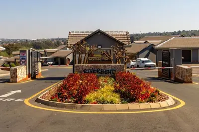a flower bed in the middle of a parking lot at Alimamaspaces The Mansons Riverbend Midrand in Midrand