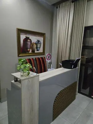 a lobby with a counter with vases on the wall at Cozy Lifestyle Guesthouse in Naboomspruit