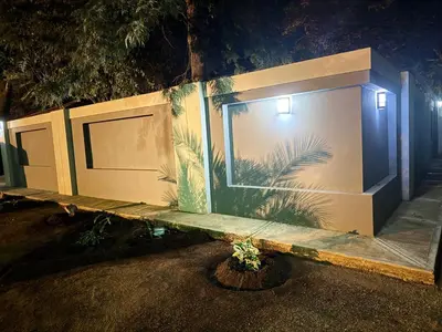 a bench in front of a building at night at Cozy Lifestyle Guesthouse in Naboomspruit