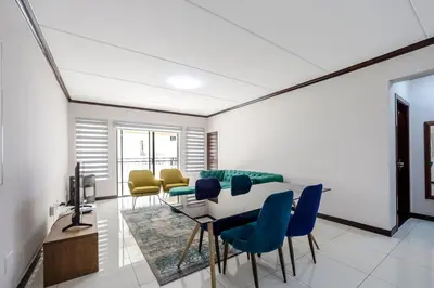 a living room with a table and chairs at AlimamaSpaces The Manson's Walford in Midrand