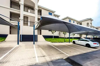 a car parked in a parking lot in front of a building at AlimamaSpaces The Manson's Walford in Midrand