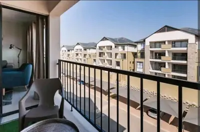 a balcony with a view of a building at AlimamaSpaces The Chelsea's Kikuyu in Midrand