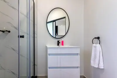 a bathroom with a sink and a mirror at AlimamaSpaces The Chelsea's Munyaka in Midrand