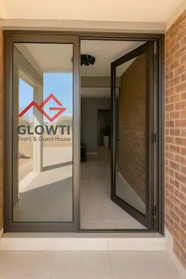 a sliding glass door with a sign for a gym and guest house at Glow Events &Guest House in Centurion