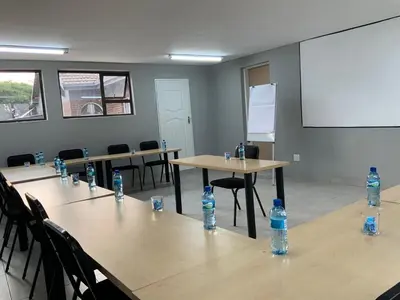 a room with tables and chairs with water bottles on them at Glowti Event & Guest House in Centurion