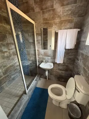 a bathroom with a toilet and a sink at Glowti Event & Guest House in Centurion
