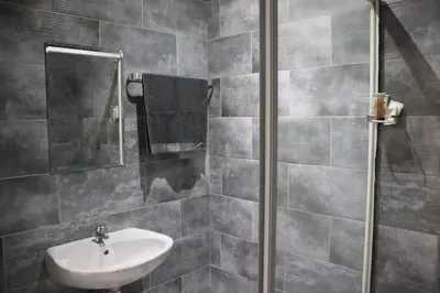 a bathroom with a sink and a mirror at Glowti Event & Guest House in Centurion
