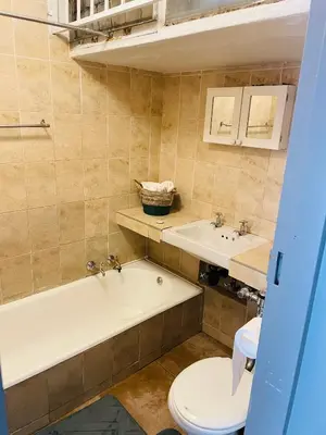 a bathroom with a tub and a toilet and a sink at Sunnyside hidden gem in Pretoria
