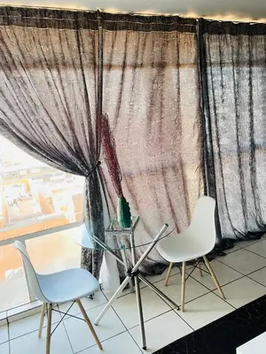 two chairs and a glass table in front of a window at Sunnyside hidden gem in Pretoria
