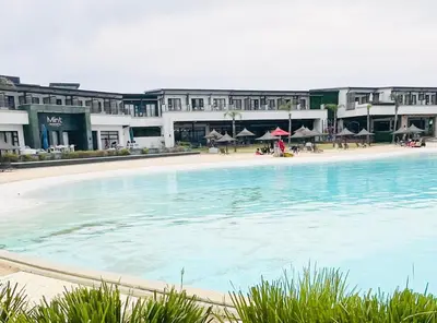 a large swimming pool in front of a building at Mish at The Blyde Crystal lagoons in Pretoria