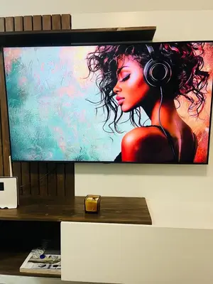 a television screen with a woman wearing headphones at Mish at The Blyde Crystal lagoons in Pretoria