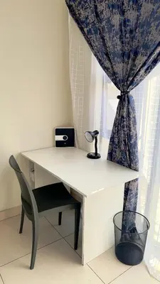 a white desk with a chair and a window at Prospect Guest House in Pretoria