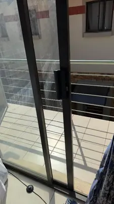 a sliding glass door with a window in a room at Prospect Guest House in Pretoria