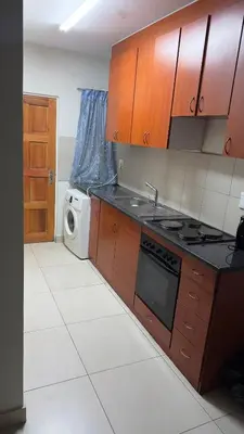 a kitchen with a stove and a microwave in it at Prospect Guest House in Pretoria