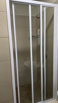 a glass shower in a bathroom with a sink at Prospect Guest House in Pretoria