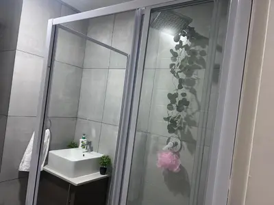 a bathroom with a shower and a sink at Private Space in a House in Pretoria