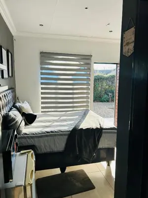 a large bed in a room with a window at Enawe Lodge in Erasmus