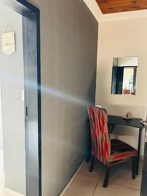 a desk in a room with a chair and a mirror at Enawe Lodge in Erasmus