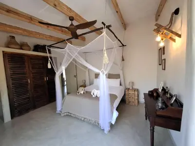 a bedroom with a bed with a canopy at TheView Marloth Lodge in Marloth Park