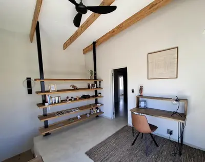 a room with a desk and a ceiling fan at TheView Marloth Lodge in Marloth Park