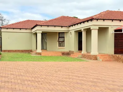 a house with a red roof and a brick driveway at Secure Home on Fuchs in Polokwane
