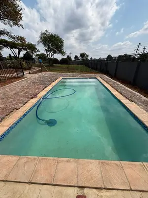 a swimming pool with a hose in the water at Glowti Events & Guest House in Centurion