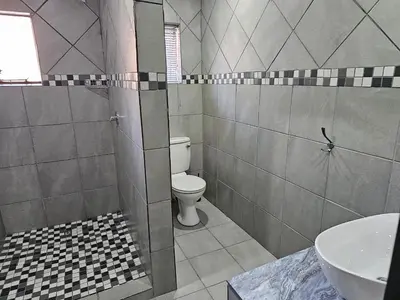 a bathroom with a toilet and a sink at 4 Trees Accommodation in Polokwane
