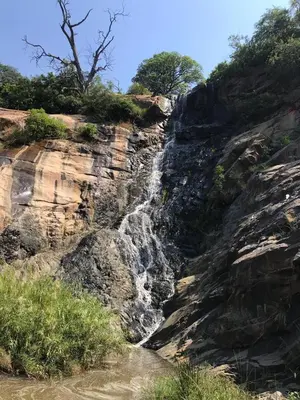 a waterfall on the side of a rocky cliff at Inkonka Game farm