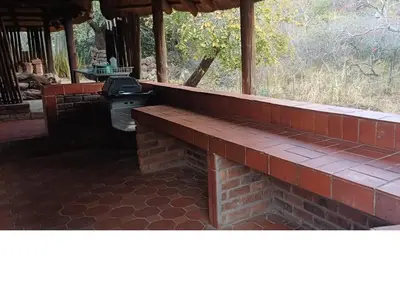 a brick patio with a grill in a house at Inkonka Game farm