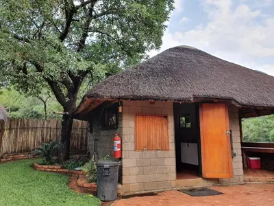 a small hut with a thatched roof at Inkonka Game farm