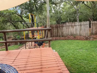 a playground with a slide in a yard at Inkonka Game farm
