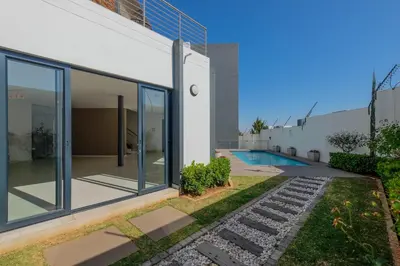 an image of a house with a swimming pool at GatesofGail Luxury Apartments in Midrand