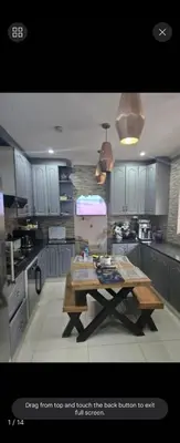 a kitchen with a table in the middle of it at Erasmia on main in Centurion