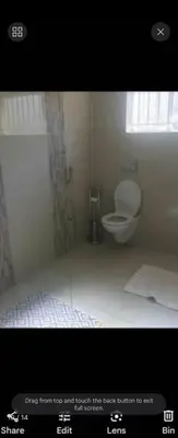 a small bathroom with a toilet and a window at Erasmia on main in Centurion