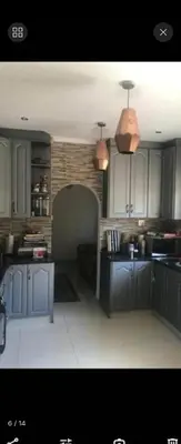 a kitchen with blue cabinets and a ceiling at Erasmia on main in Centurion