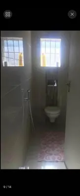 a bathroom with a toilet and a window at Erasmia on main in Centurion