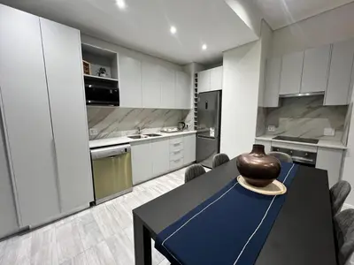 a kitchen with a table with a vase on it at Continental Menlyn Maine Residence in Pretoria