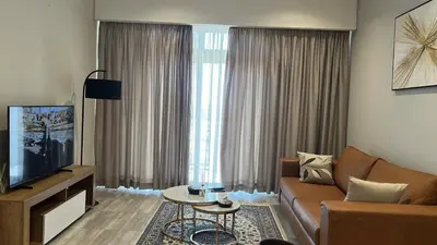 a living room with a couch and a tv at Continental Menlyn Maine Residence in Pretoria