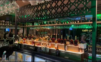 a bar with a lot of bottles of alcohol at Continental Menlyn Maine Residence in Pretoria