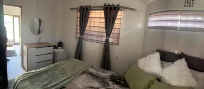 a small bedroom with a bed and a window at 22 impala Ave in Kempton Park