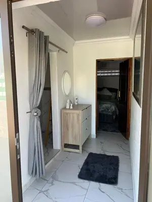 a bedroom with a bed and a dresser and a mirror at 22 impala Ave in Kempton Park
