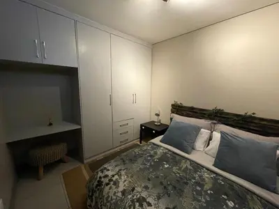 a bedroom with a bed and a white cabinet at The Centurion Sunset in Centurion