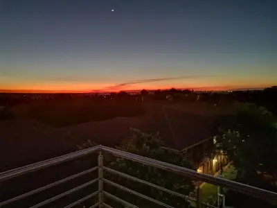 a sunset from the balcony of a house at The Centurion Sunset in Centurion