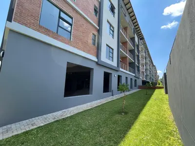 a building with a grassy yard next to a building at The Centurion Sunset in Centurion