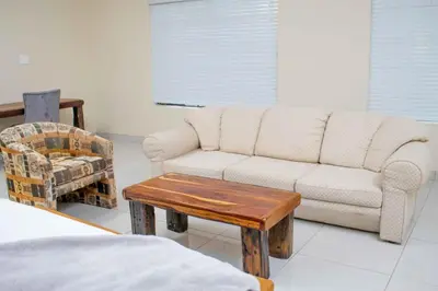 a living room with a couch and a chair at Wildlife Oasis in Marloth Park