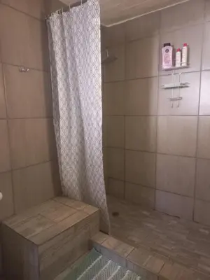 a shower with a shower curtain in a bathroom at Ormonde guesthouse in Pretoria